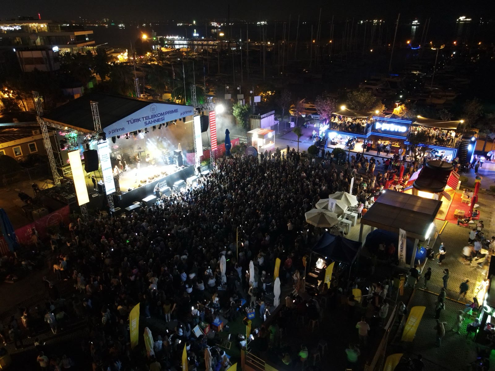 Night aerial of the concert stage and a packed crowd